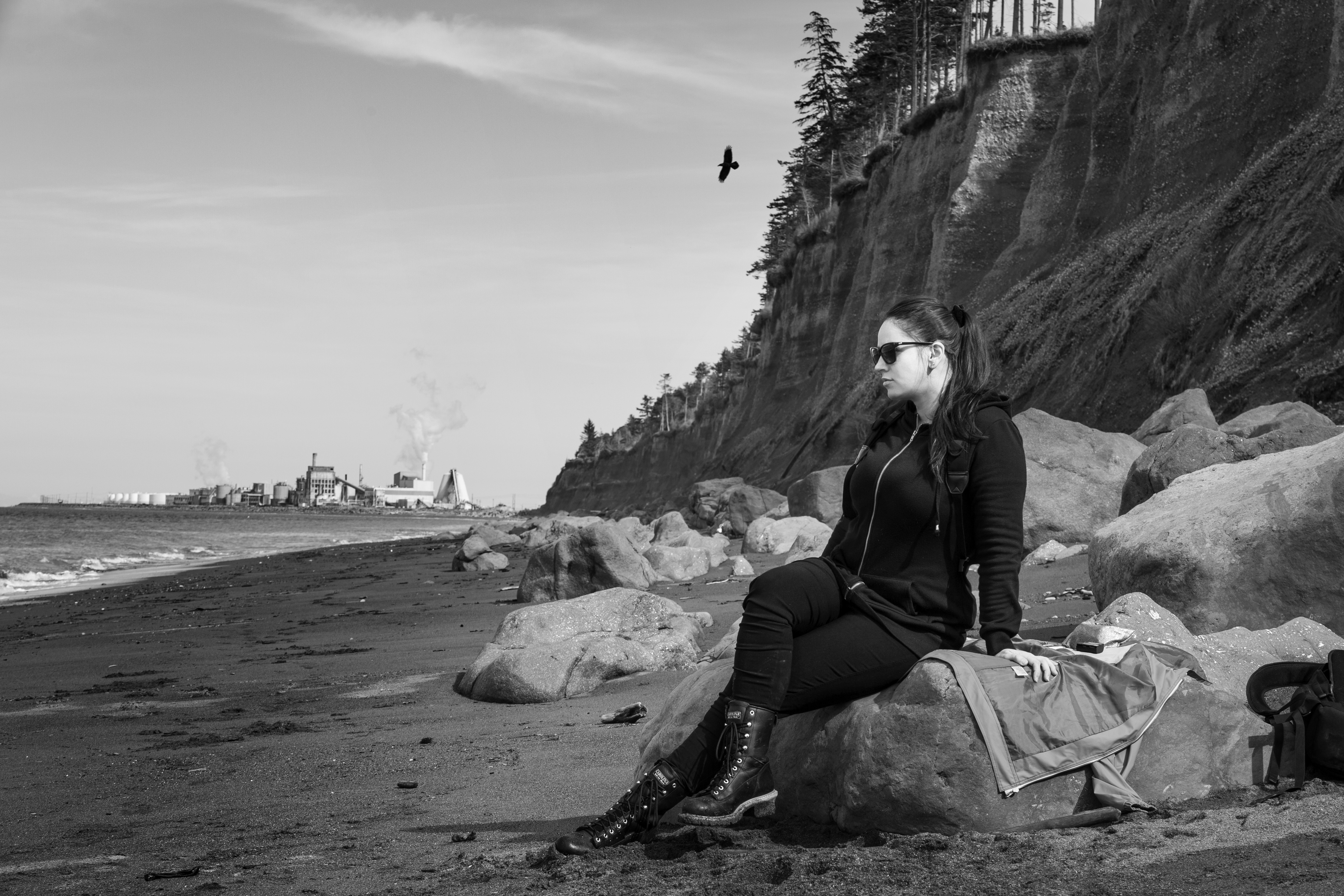 Alaina Ciceri sitting on rocks at the beach, Port Angeles — Odd Crow Media
